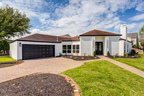 a front view of a house with yard and porch