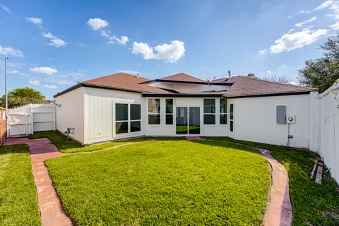 a aerial view of a house with swimming pool and a yard