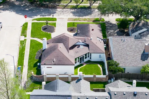 a aerial view of a house with a yard and plants