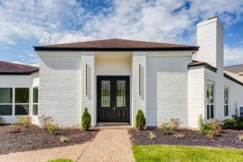 a front view of a house with garden