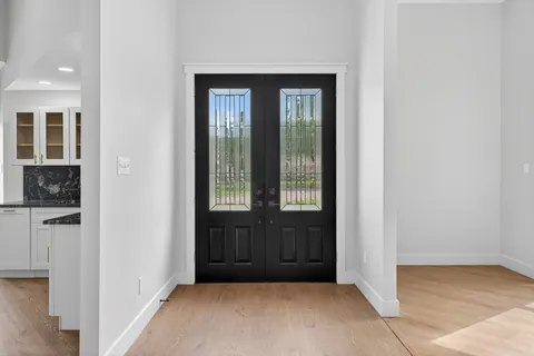 a living room with couch and a floor to ceiling window