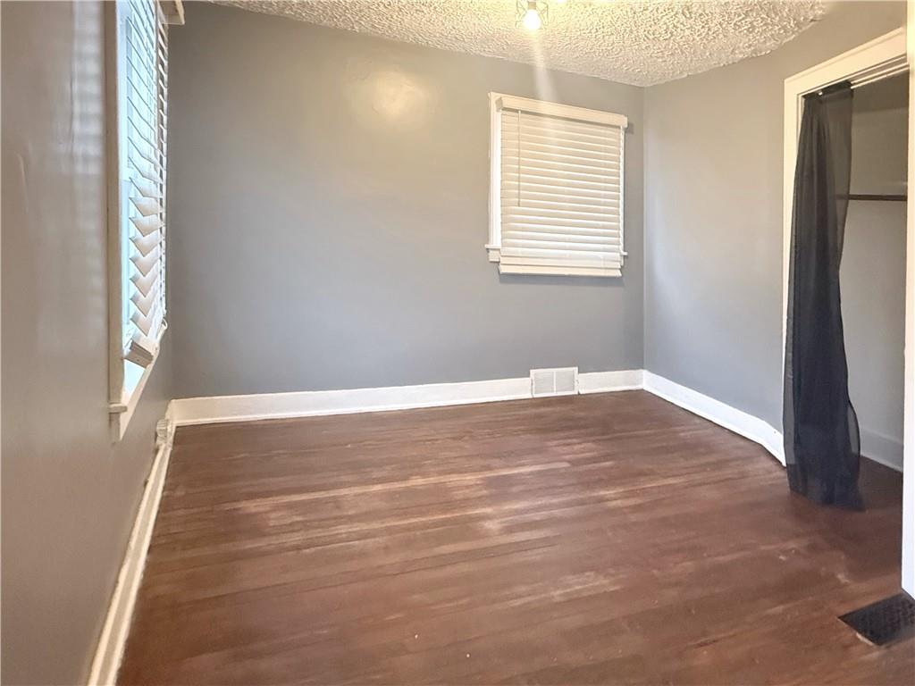 389 Webster Street Rochester, PA 15074 - Photo 11 of 24 a view of an empty room with wooden floor and a window