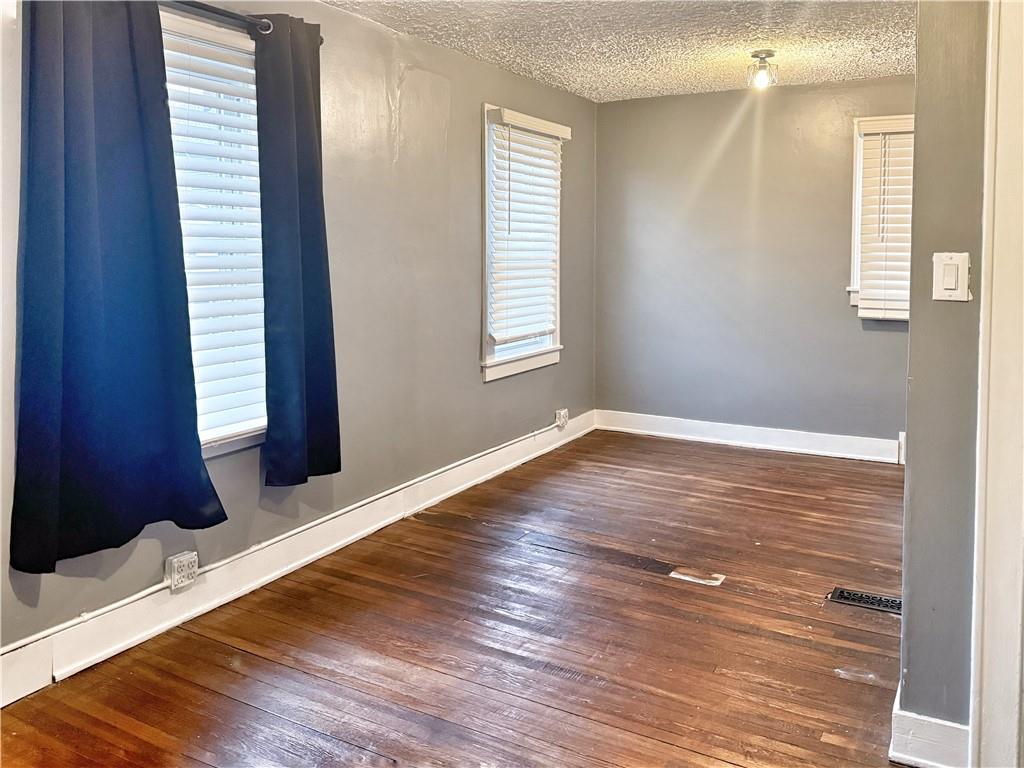 389 Webster Street Rochester, PA 15074 - Photo 13 of 24 a view of an empty room with wooden floor and a window
