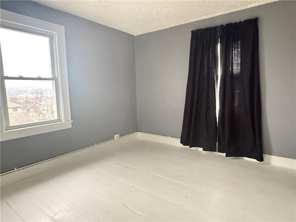 389 Webster Street Rochester, PA 15074 - Photo 18 of 24 a bed room with a bed and a window