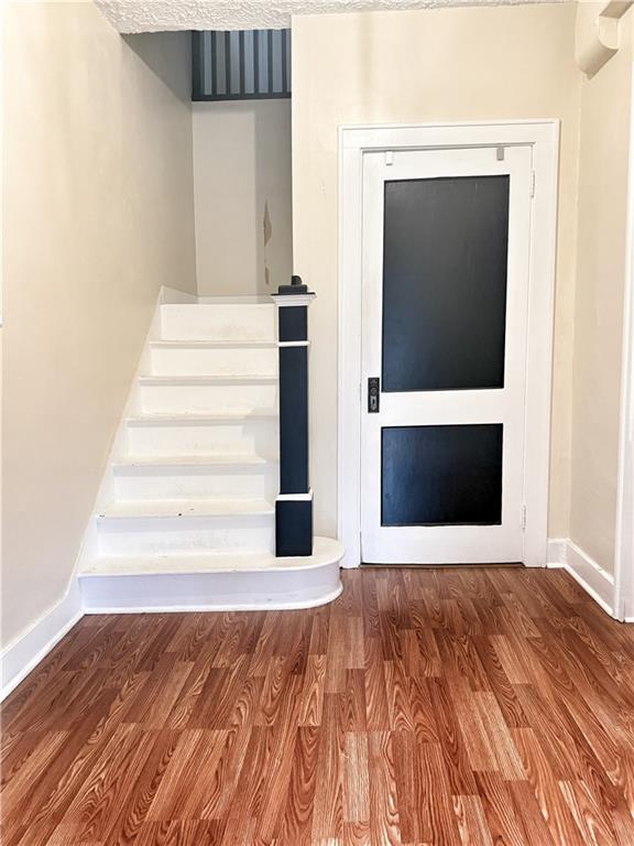 389 Webster Street Rochester, PA 15074 - Photo 2 of 24 a view of an empty room with wooden floor and a fireplace