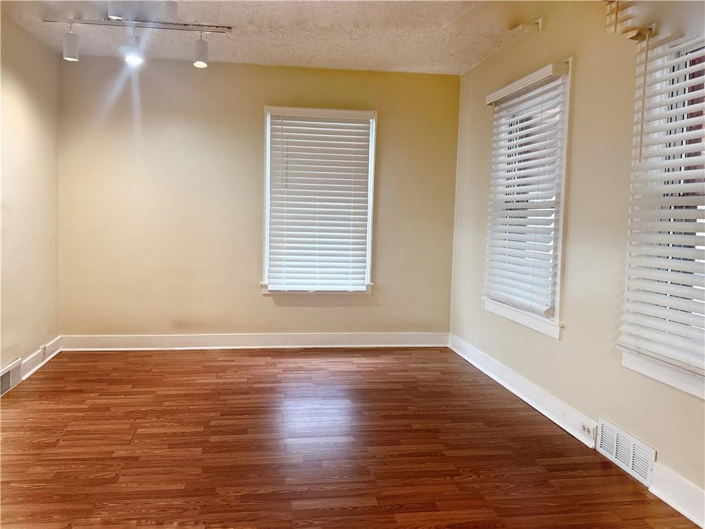 389 Webster Street Rochester, PA 15074 - Photo 3 of 24 a view of an empty room with wooden floor and a window