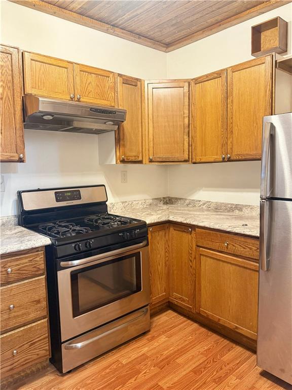389 Webster Street Rochester, PA 15074 - Photo 4 of 24 a kitchen with granite countertop a stove top oven cabinets and a refrigerator