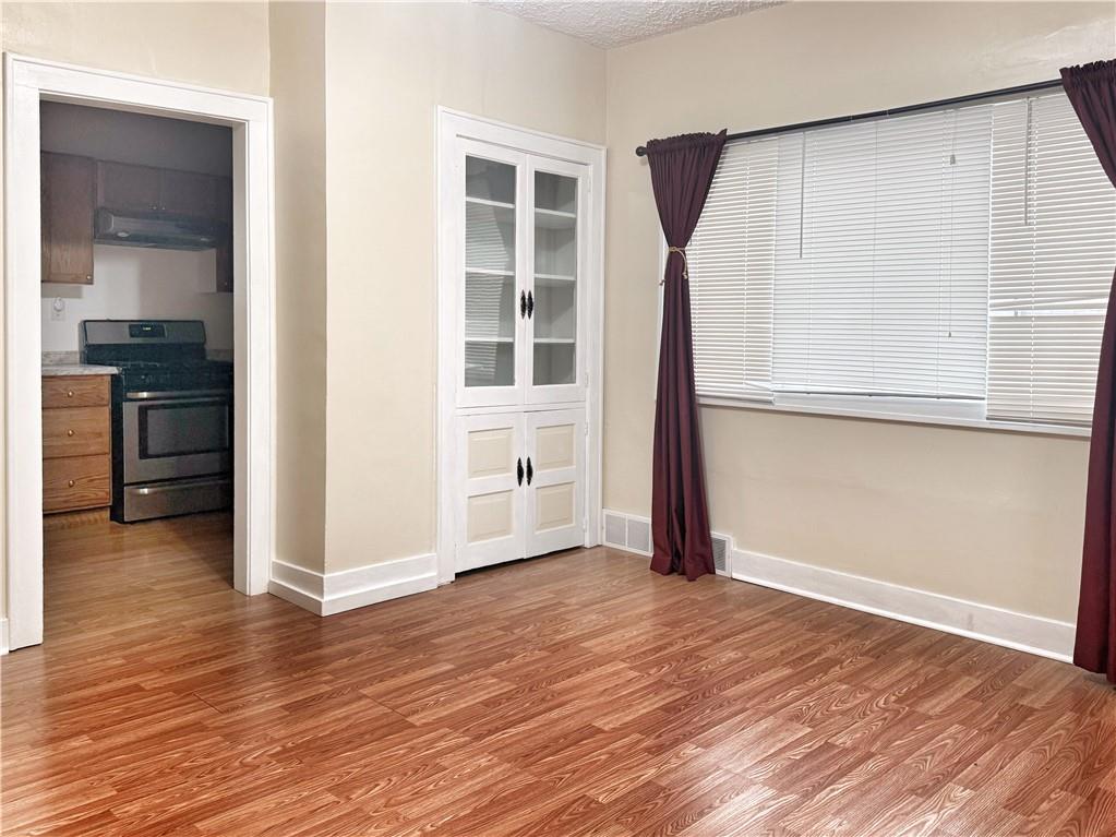 389 Webster Street Rochester, PA 15074 - Photo 8 of 24 an empty room with wooden floor and windows