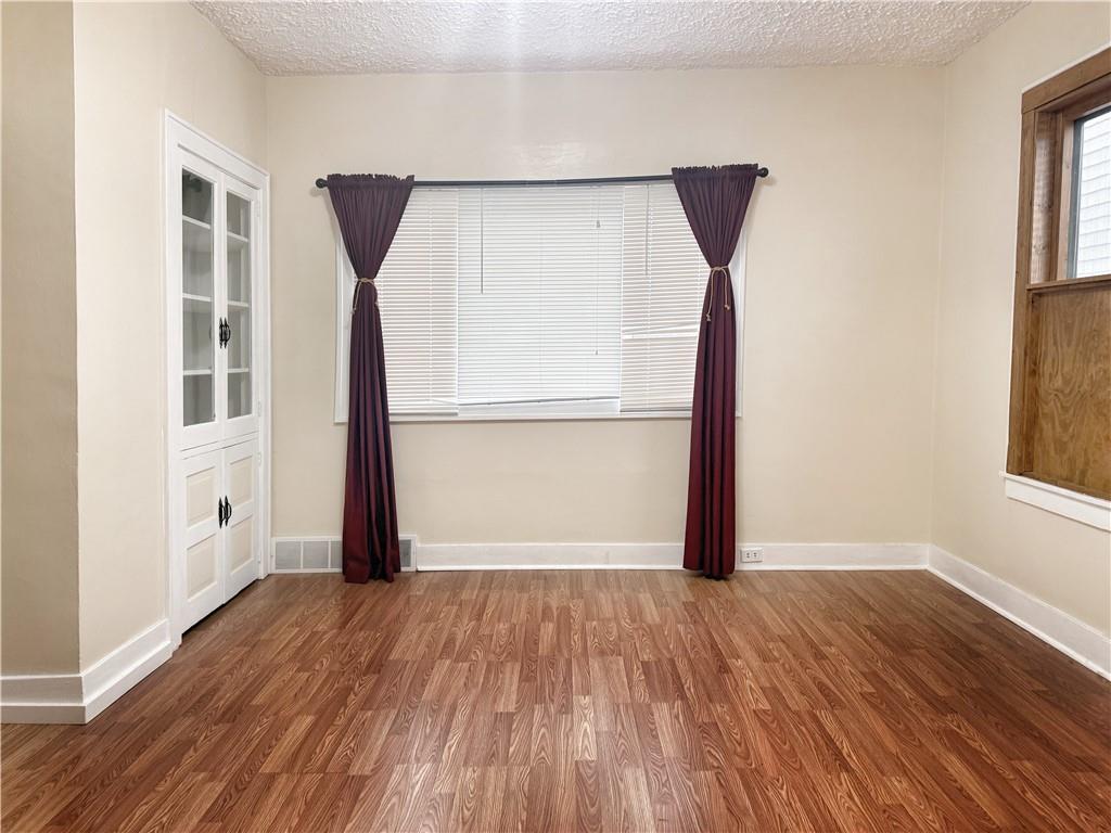 389 Webster Street Rochester, PA 15074 - Photo 9 of 24 an empty room with wooden floor and a window