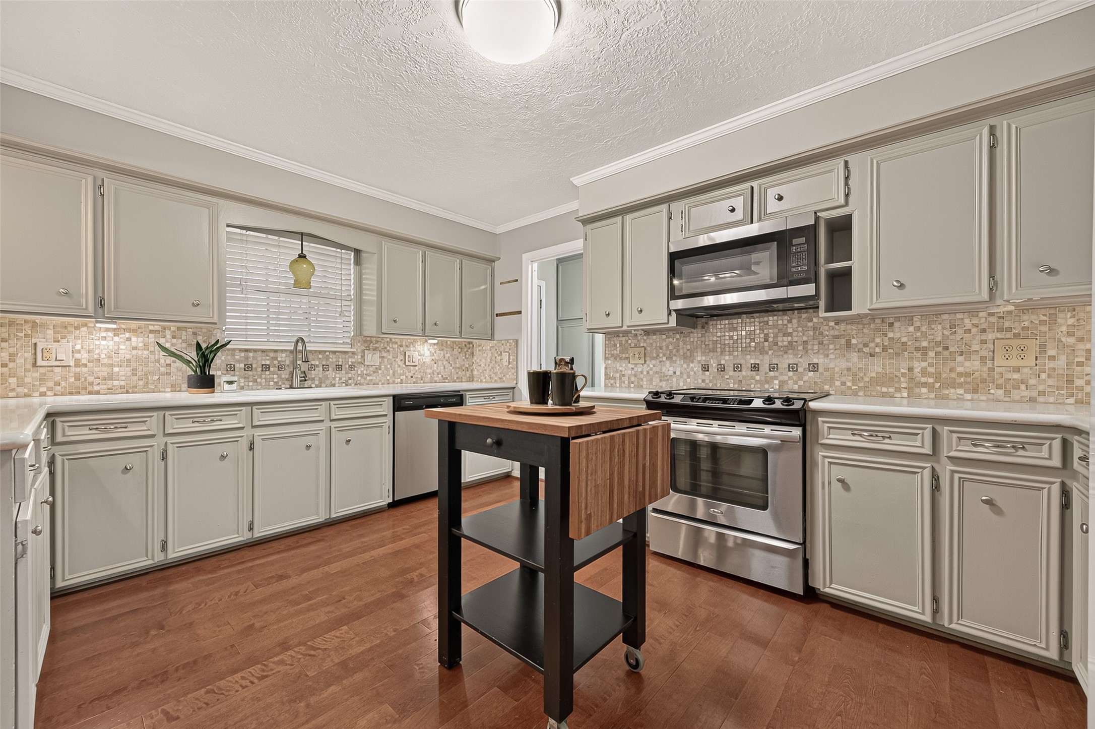 8007 Vickridge Lane Spring, TX 77379 - Photo 13 of 44 A well-appointed kitchen with abundant cabinetry, stainless-steel appliances, and a movable island for added prep and serving space
