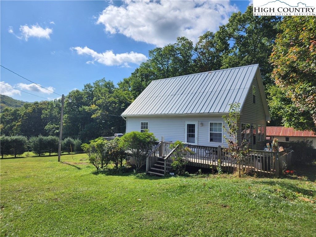 369 Ransey Woodring Road Todd, NC 28684 - Photo 1 of 6 a view of a house with backyard and sitting area