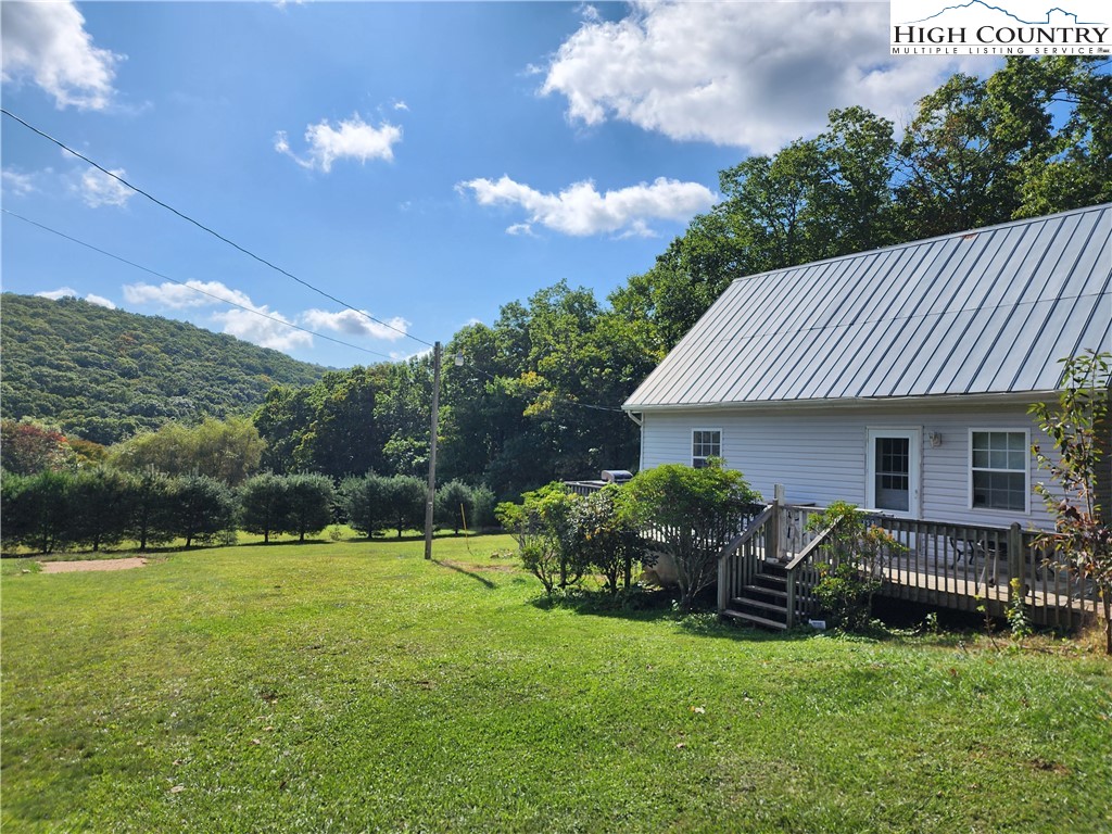 369 Ransey Woodring Road Todd, NC 28684 - Photo 4 of 6 a view of a house with backyard and sitting area
