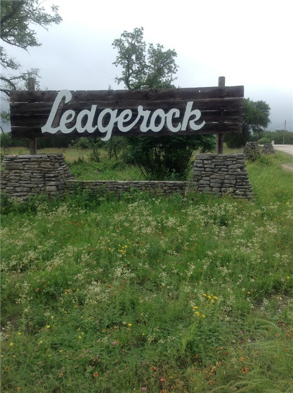 200 Round Rock Road Wimberley, TX 78676 - Photo 1 of 1 a view of a street sign and a yard of the house