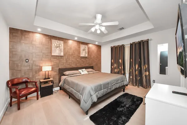 a bedroom with a bed and a chandelier