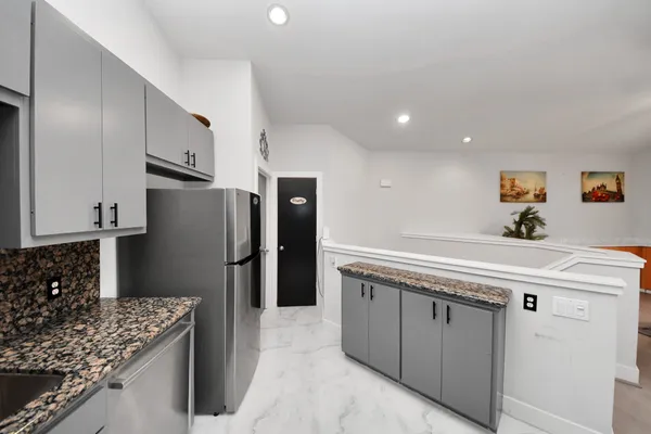 a kitchen with stainless steel appliances granite countertop a sink stove and refrigerator