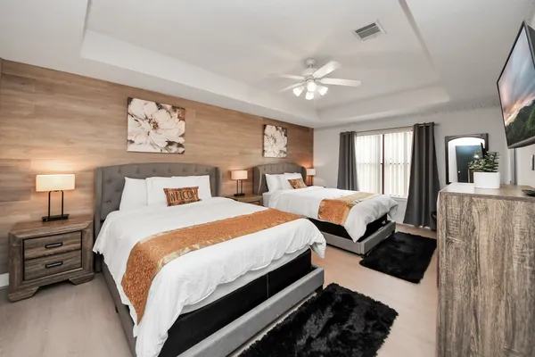 a bedroom with beds and a large mirror