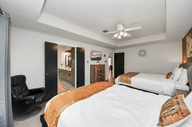 a bedroom with a bed and a chandelier