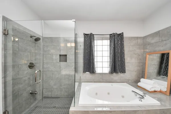 a bathroom with a bathtub and shower