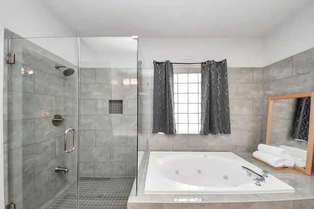 a bathroom with a bathtub and shower