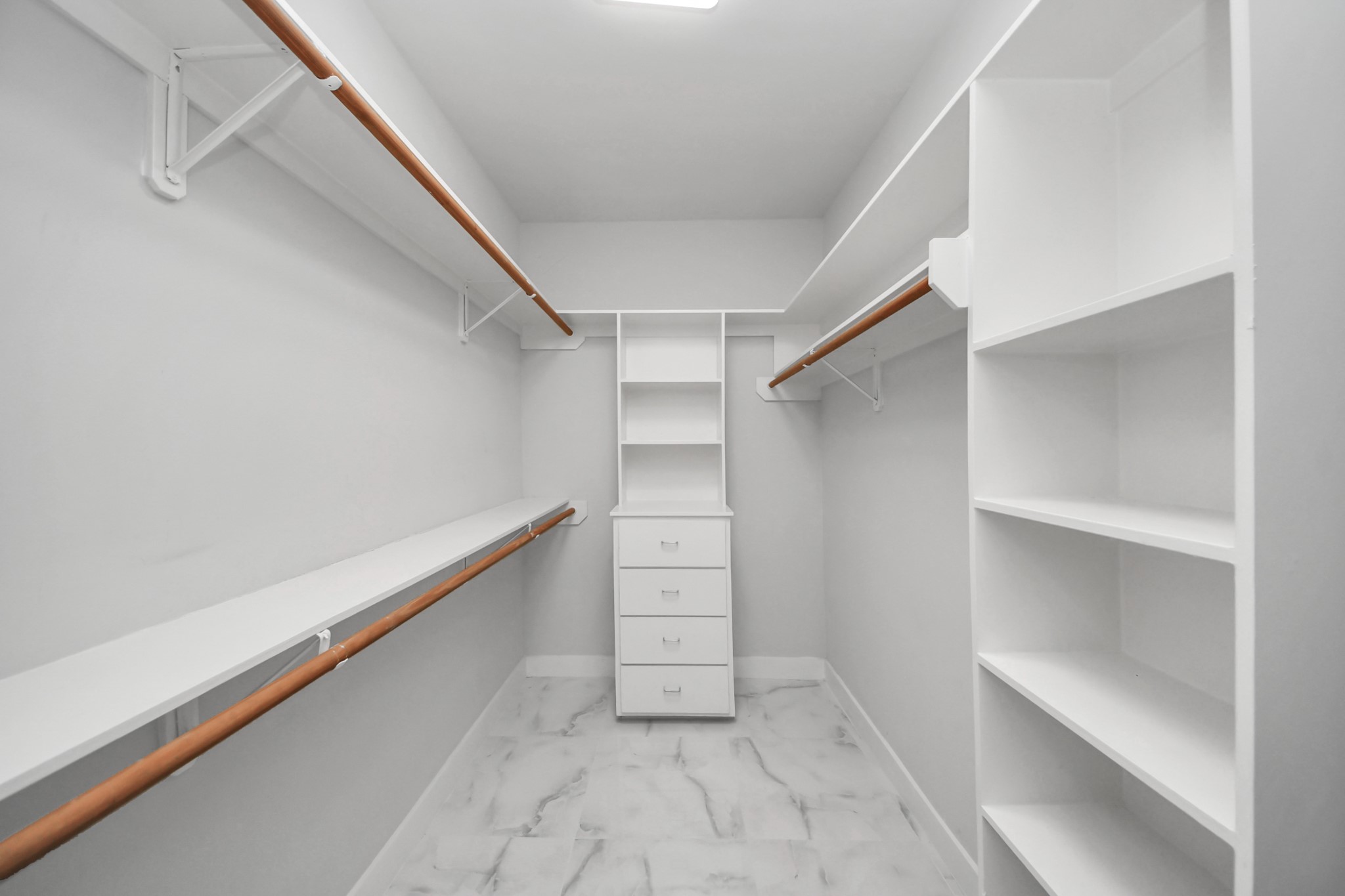 9715 Riddlewood Lane Houston, TX 77025 - Photo 37 of 43 Spacious primary closet with ample shelving and hanging space, perfect for organizing your wardrobe.