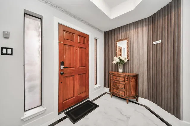 a view of an entryway with wooden floor