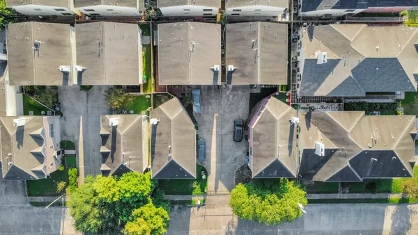 an aerial view of a house with a garden and a potted plant