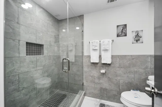 a bathroom with a toilet and a shower