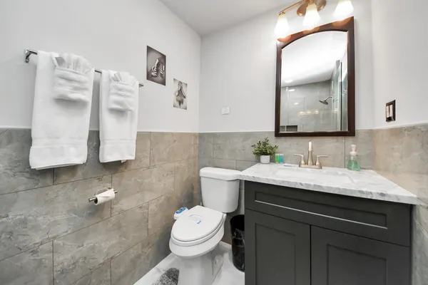 a bathroom with a granite countertop sink and a mirror