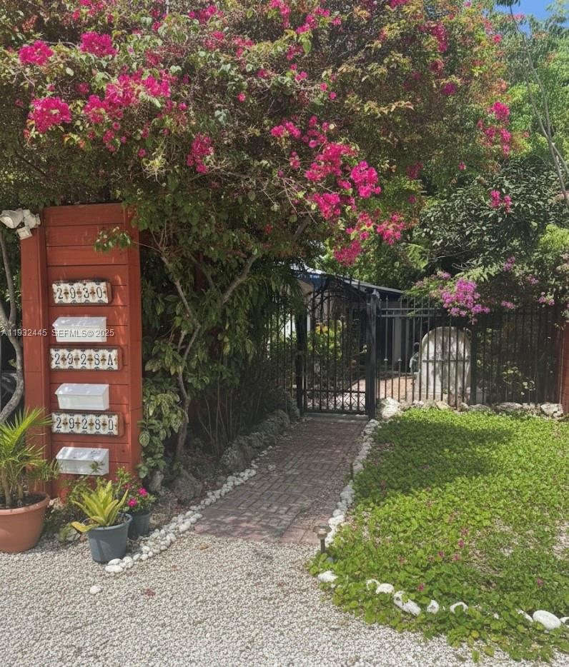 a front view of a house with a yard and fountain