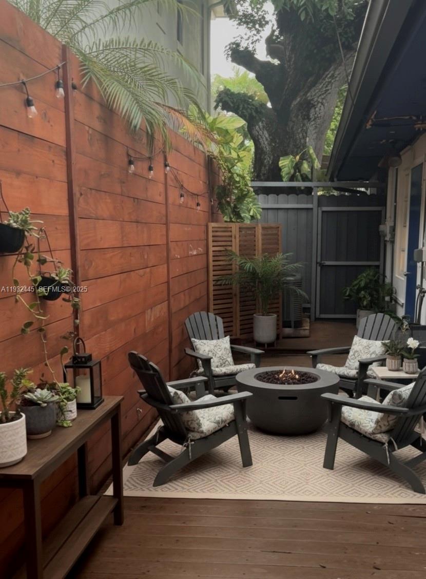 2928 Louise Street Miami, FL 33133 - Photo 4 of 11 a view of a roof deck with couches and potted plants