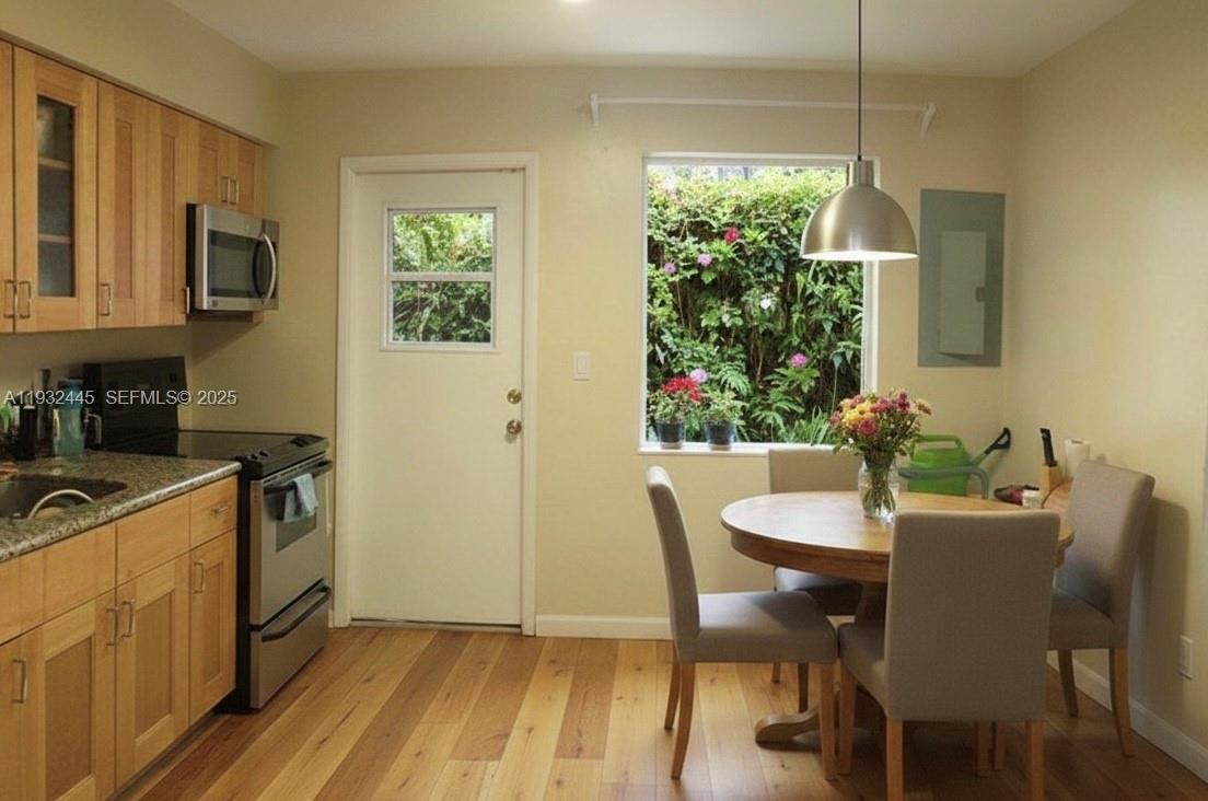 2928 Louise Street Miami, FL 33133 - Photo 6 of 11 a view of a dining room with furniture window and wooden floor