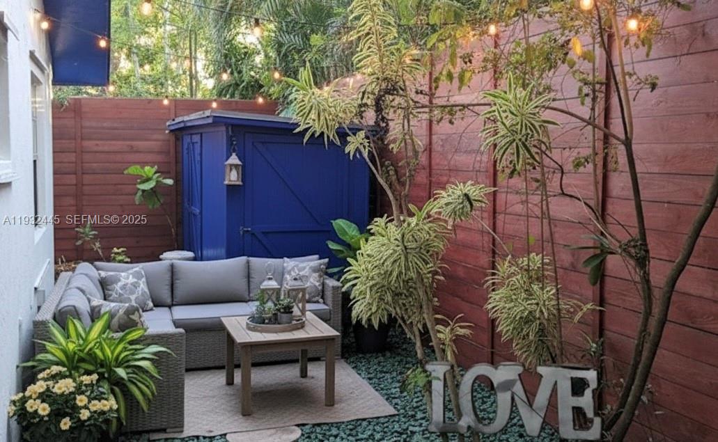 2928 Louise Street Miami, FL 33133 - Photo 8 of 11 a backyard of a house with table and chairs