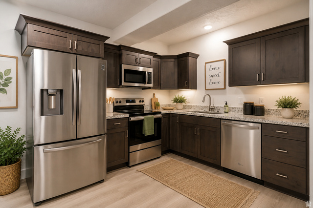 4572 Flower Point Eagle Mountain, UT 84005 - Photo 53 of 62 Modern kitchen featuring dark wood cabinetry, stainless steel appliances, speckled countertops, undermount sink, and recessed lighting