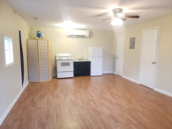 a view of a kitchen with a dishwasher cabinets and wooden floor