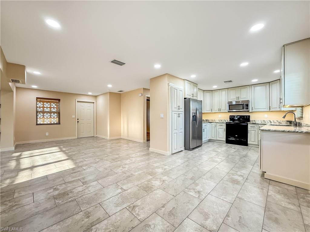 2115 St Croix Avenue Fort Myers, FL 33905 - Photo 37 of 37 Kitchen featuring open floor plan, stainless steel appliances, light stone countertops, and recessed lighting