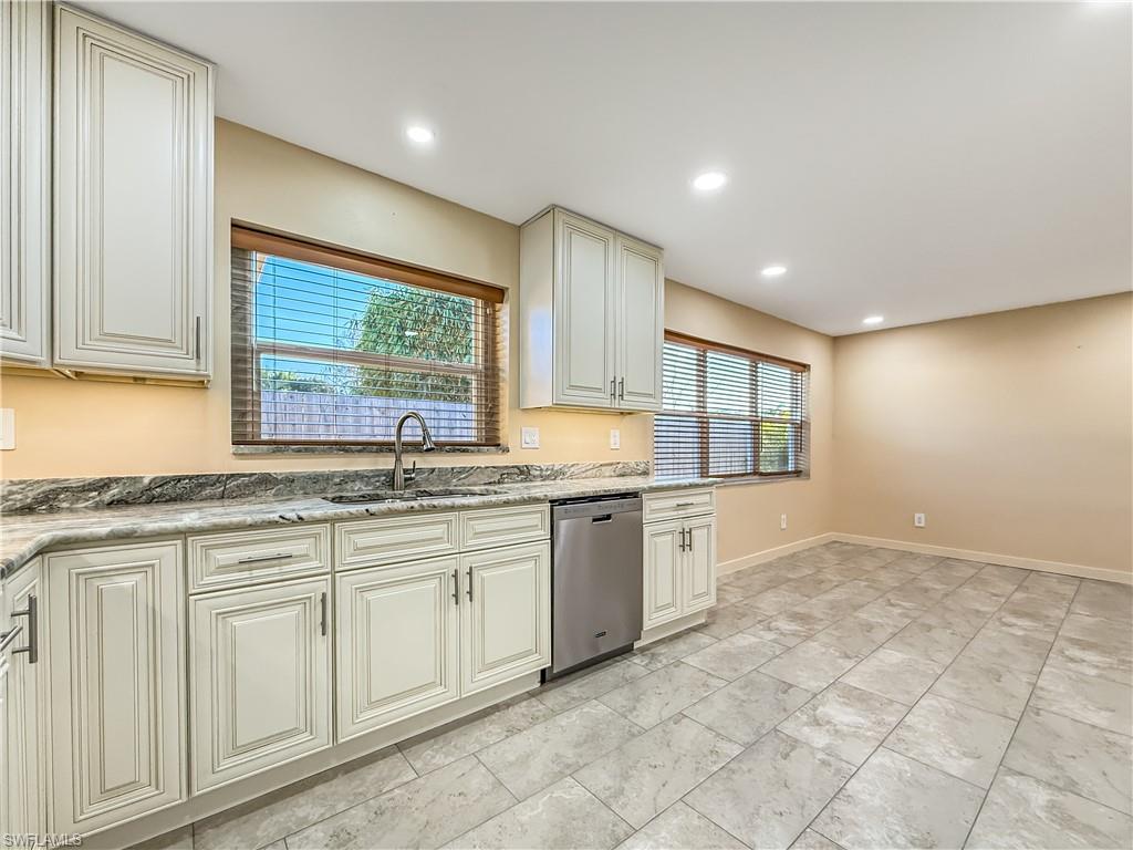 2115 St Croix Avenue Fort Myers, FL 33905 - Photo 14 of 37 Kitchen featuring cream cabinets, dishwasher, light stone counters, and recessed lighting