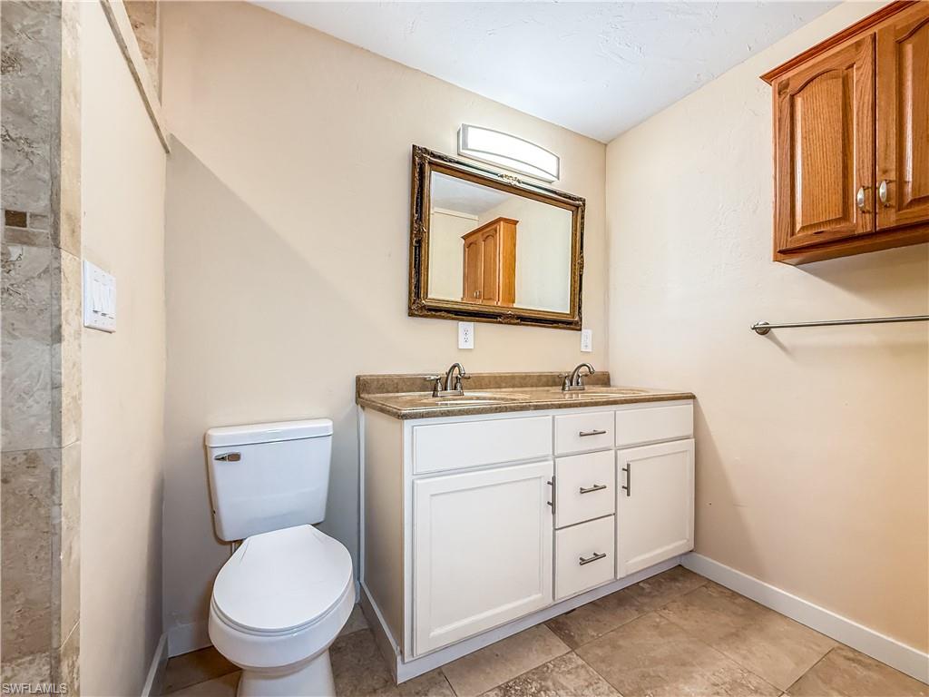 2115 St Croix Avenue Fort Myers, FL 33905 - Photo 17 of 37 Full bath with double vanity and tiled shower