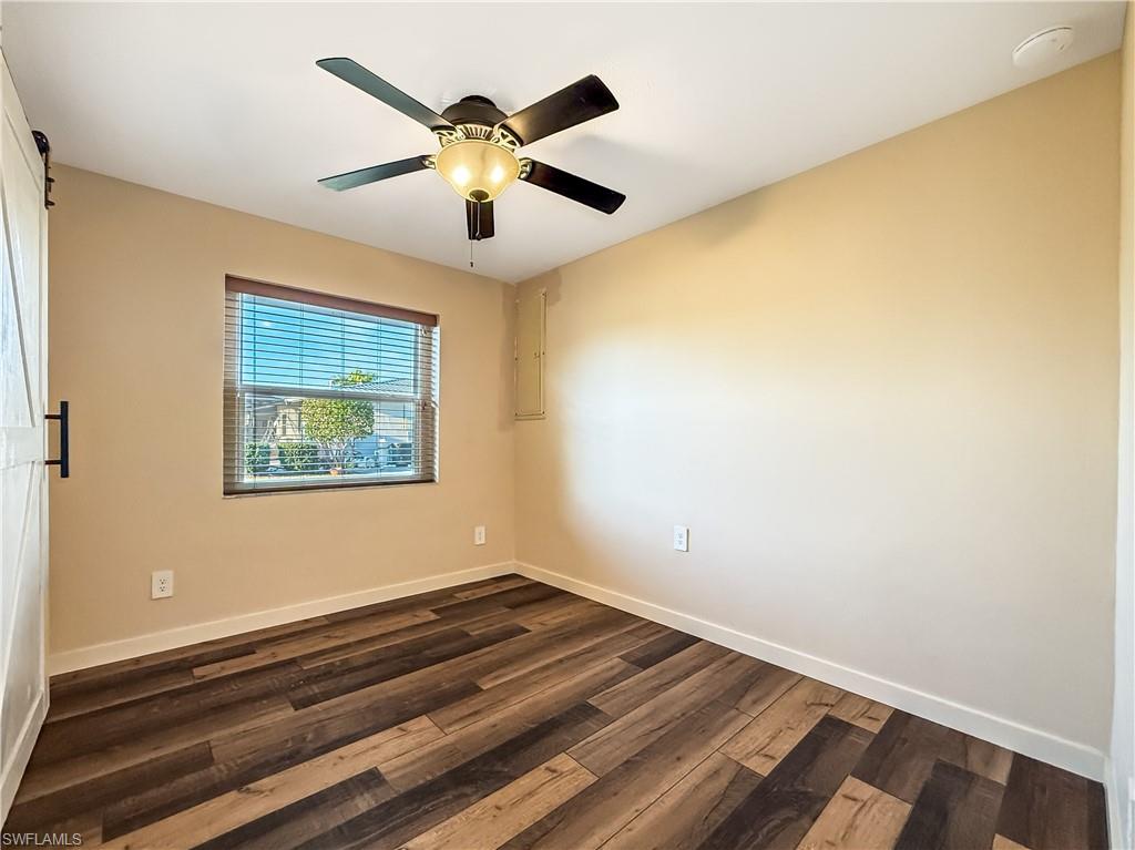 2115 St Croix Avenue Fort Myers, FL 33905 - Photo 19 of 37 Empty room featuring dark wood finished floors and ceiling fan