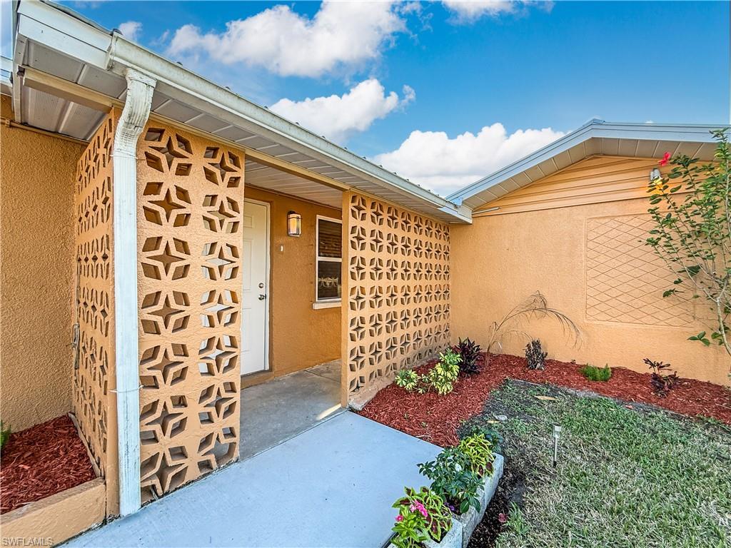 2115 St Croix Avenue Fort Myers, FL 33905 - Photo 4 of 37 View of exterior entry featuring stucco siding