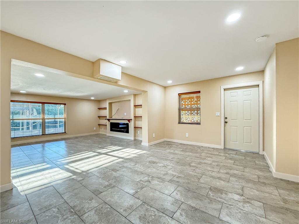 2115 St Croix Avenue Fort Myers, FL 33905 - Photo 9 of 37 Unfurnished living room featuring built in shelves and recessed lighting