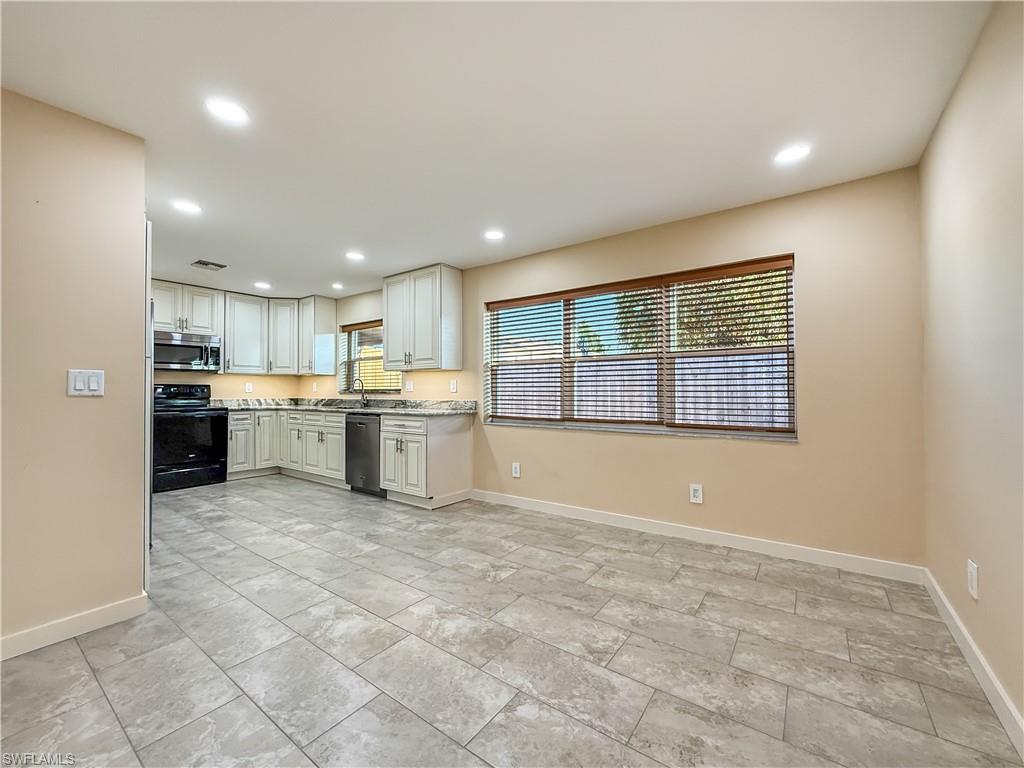 2115 St Croix Avenue Fort Myers, FL 33905 - Photo 10 of 37 Kitchen featuring stainless steel appliances, recessed lighting, and white cabinets