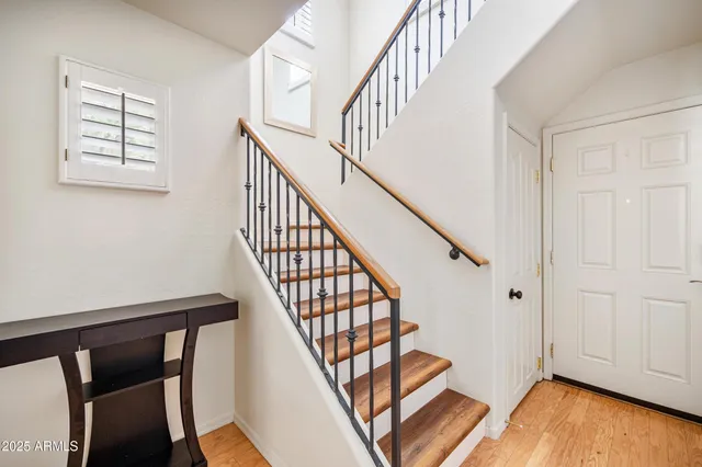 a view of entryway with wooden floor and stairs