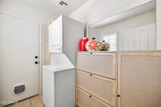 a utility room with cabinets washer and dryer