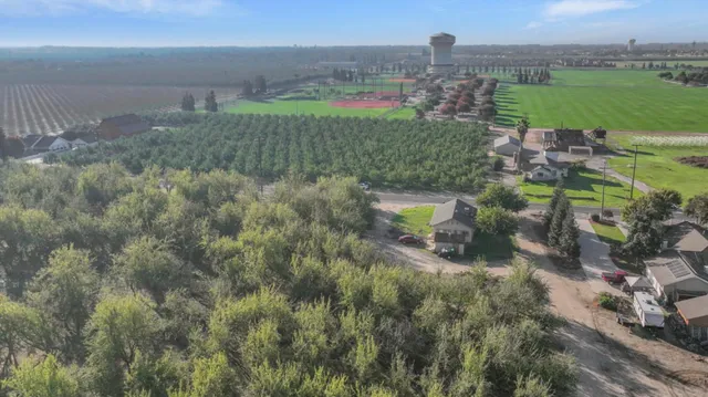 an aerial view of a house with a garden and lake view