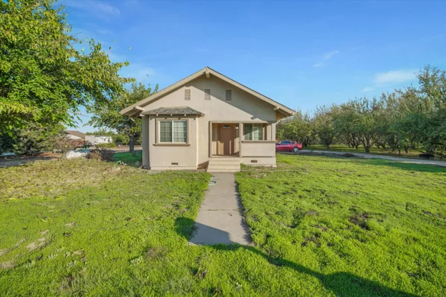 a front view of house with yard and green space