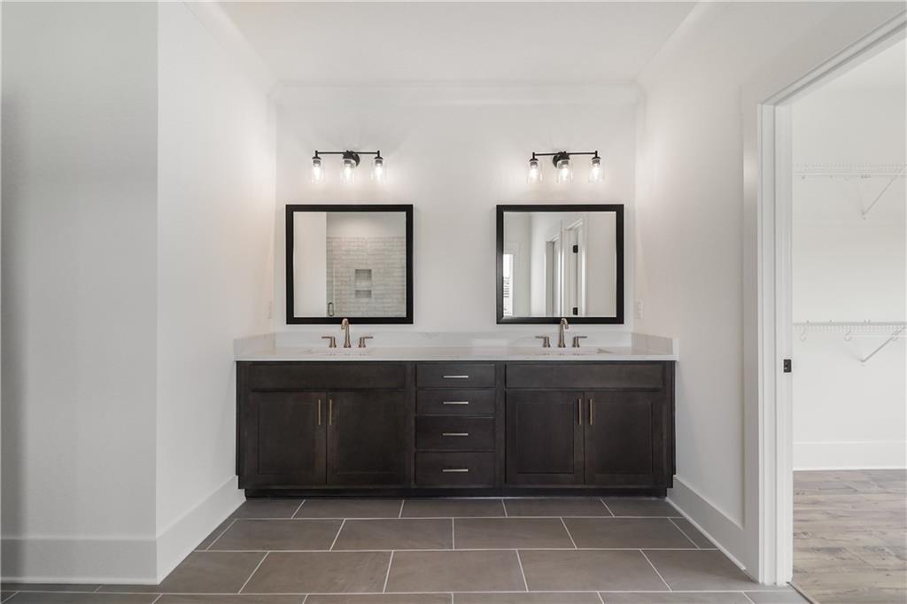 2113 Stonegate Way Monroe, GA 30656 - Photo 29 of 43 a bathroom with double vanity and a mirror