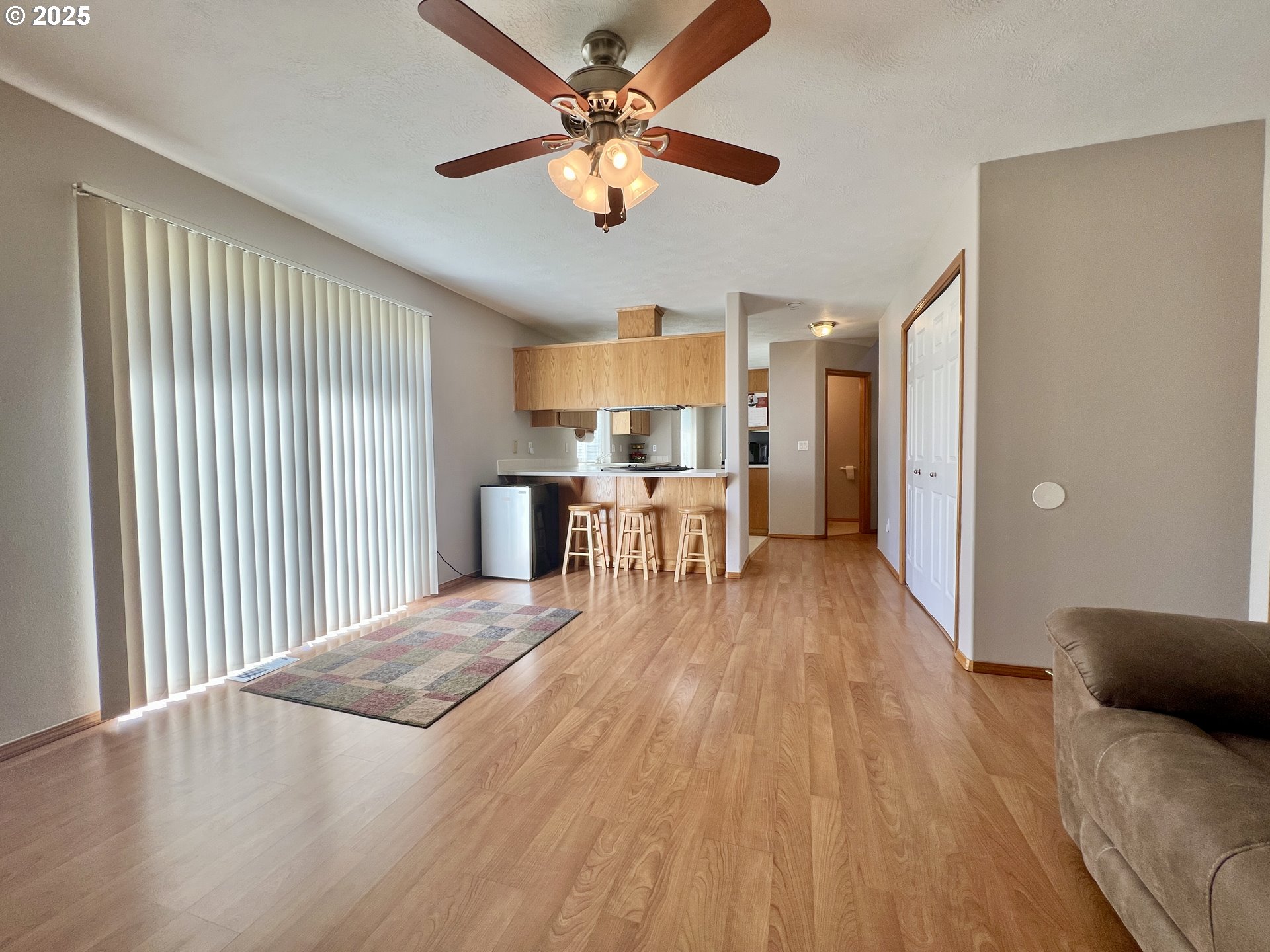 112 Northeast 11th Street Hermiston, OR 97838 - Photo 12 of 23 a view of a livingroom with furniture a ceiling fan and wooden floor