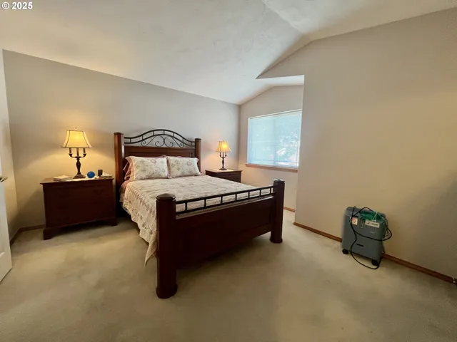 a bed room with a bed and a lamp