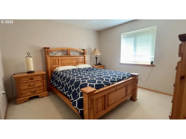 a bedroom with a bed and window