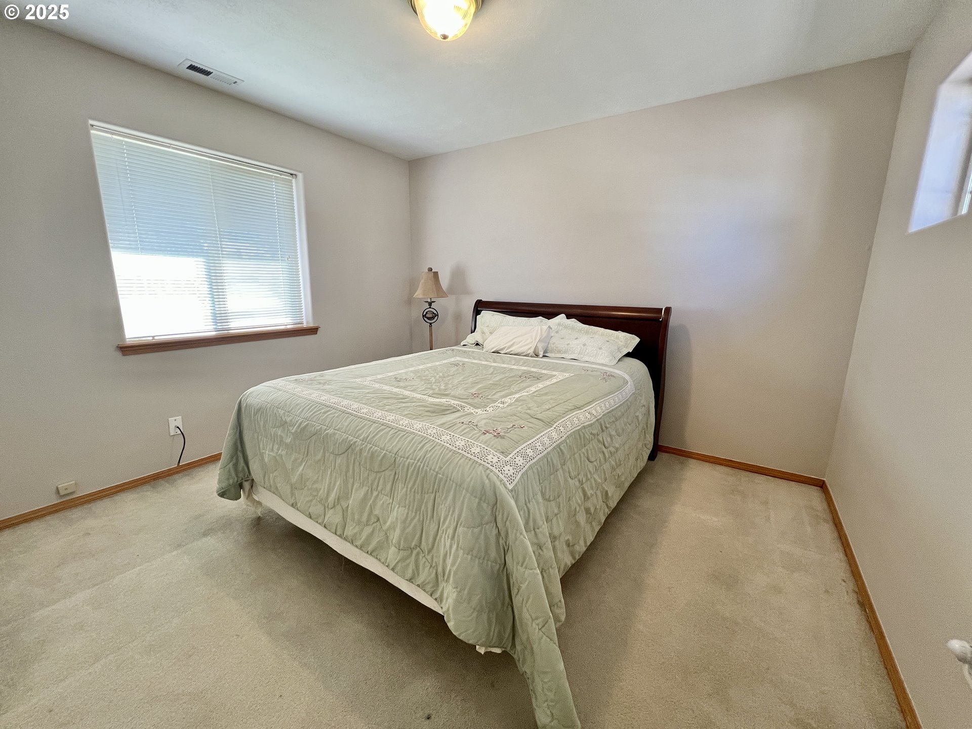 112 Northeast 11th Street Hermiston, OR 97838 - Photo 21 of 23 a bed sitting in a bedroom next to a window